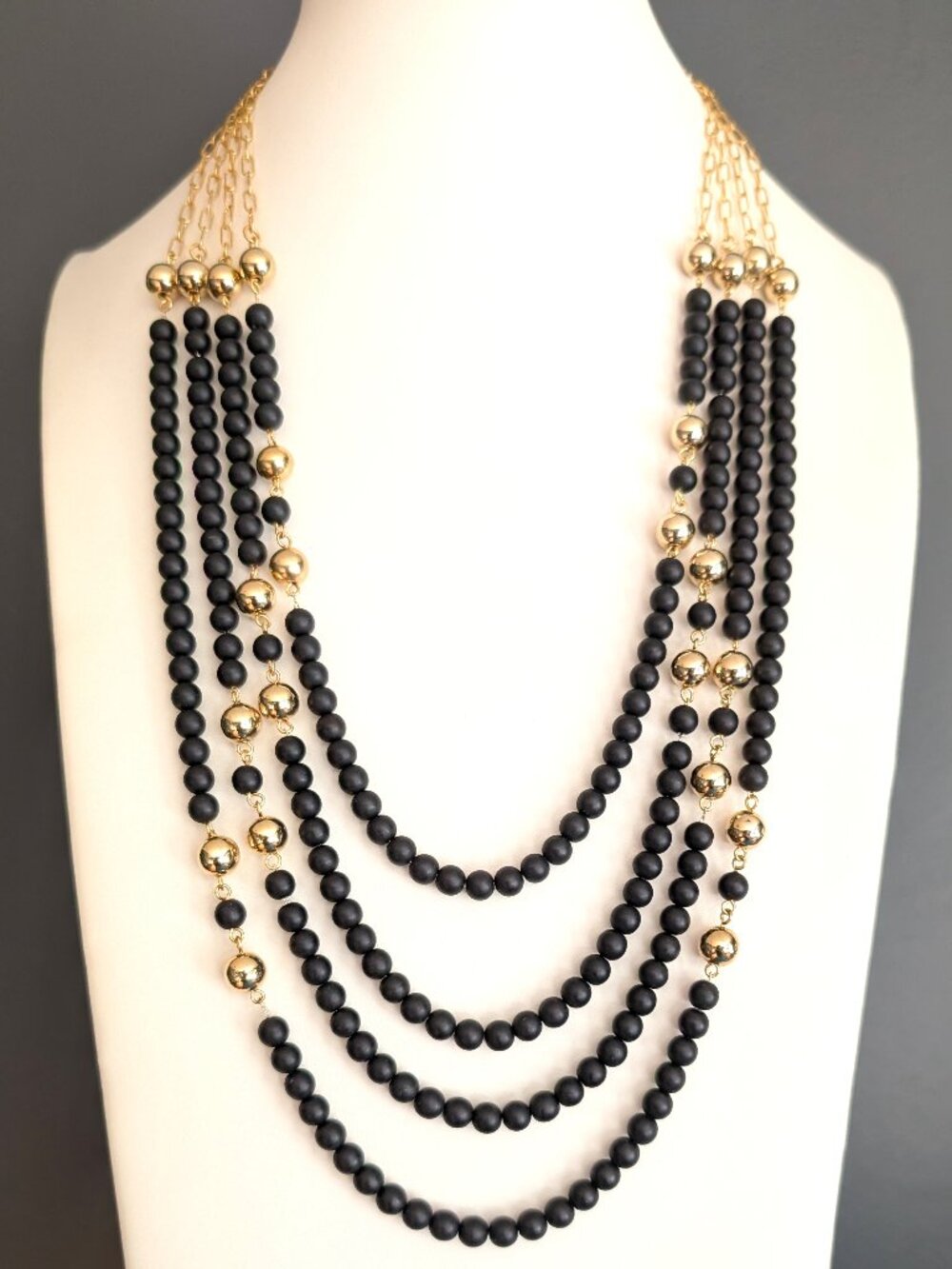 4 strand black and gold bead layered necklace